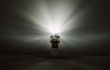 Spain, Carino, beaming lighthouse in a foggy night - RAEF001407