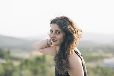 Portrait of smiling woman with hand in her hair - SKCF000162