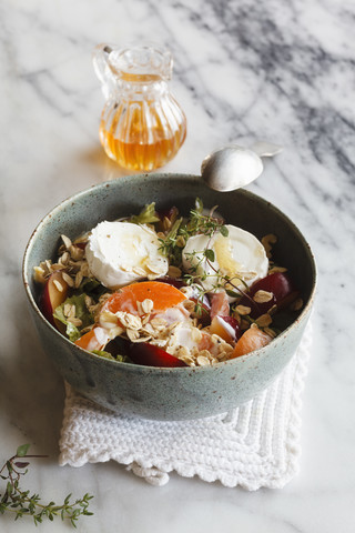 Hearty oat flakes bowl with fruits, goat cheese and thyme stock photo