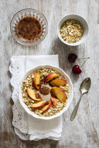 Cherry smoothie bowl with peach and oat flakes, topping stock photo