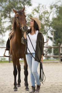 Young woman with horse at riding stable - ZOCF000126