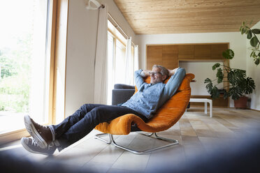Confident mature man relaxing in armchair - RBF004860