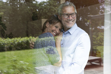 Happy mature couple looking out of window - RBF004898