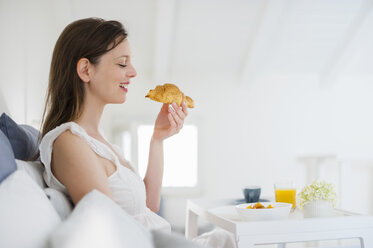 Frau im Bett sitzend mit Frühstückstablett - DIGF000950