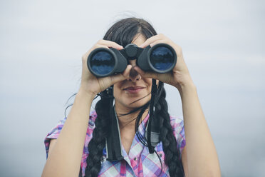 Woman looking through binocular - DAPF000253