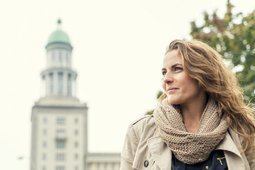 Germany, Berlin, smiling blond woman looking at distance - TAMF000553