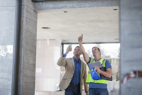 Zwei Männer unterhalten sich auf einer Baustelle - ZEF009439