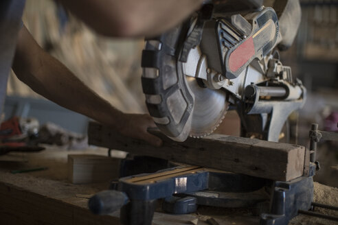 Carpenter working with circular saw in workshop - ZEF009513