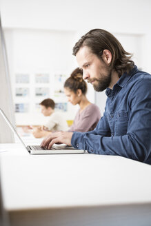 Kollegen im Büro arbeiten am Laptop - RBF004915