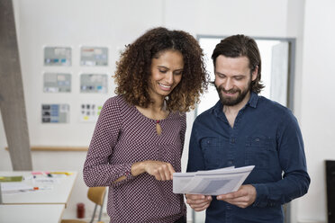 Zwei Kollegen besprechen Papiere im Büro - RBF004969