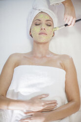 Young woman in spa receiving facial mask - ZEF009553