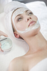 Young woman in spa receiving facial mask - ZEF009554