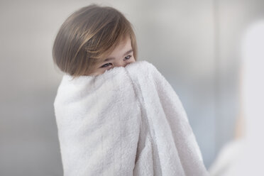 Little girl wrapped in a towel hiding her face - ZEF009605