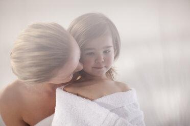 Young woman and little girl wrapped in a towel - ZEF009607