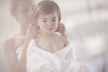 Young woman and little girl wrapped in a towel - ZEF009608