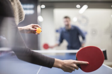 Two colleagues playing table tennis in office break room - ZEF009708