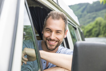 Portrait of smiling man in van - FMKF002804