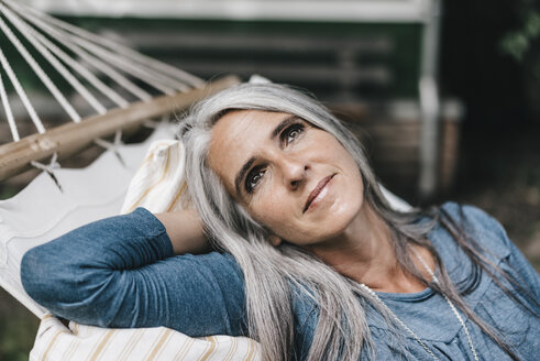 Portrait of relaxed woman lying in a hammock - KNSF000285