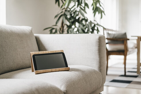 Regal mit Tablet auf der Couch - KNSF000323