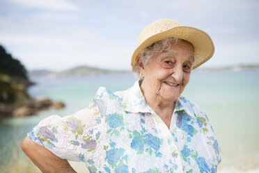 Portrait of smiling senior woman wearing straw hat - RAEF001411