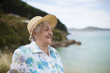 Smiling senior woman wearing straw hat - RAEF001414