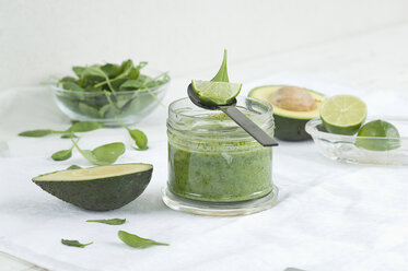 Glass of spinach avocado lime smoothie and ingredients - ASF005982