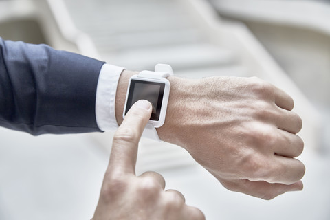 Businessman touching smartwatch stock photo