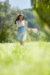 Young woman, blue dress, on meadow - MAEF011937