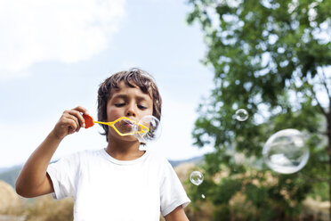 Little boy blowing soap bubbles - VABF000754