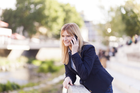 Smiling blond businesswoman on the phone stock photo