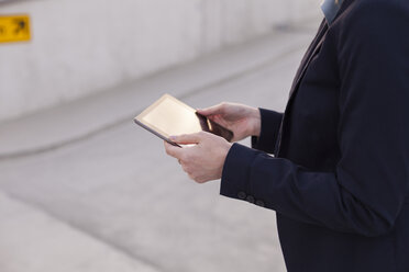 Businesswoman with mini tablet, partial view - NAF000047