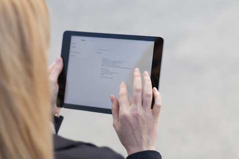 Businesswoman using tablet, close-up stock photo