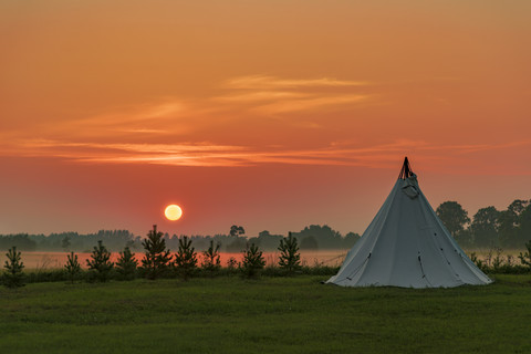 Estonia, Lahemaa National Park at sunset, tent on meadow stock photo