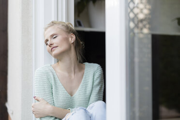 Blond woman relaxing at terrace door - SHKF000666