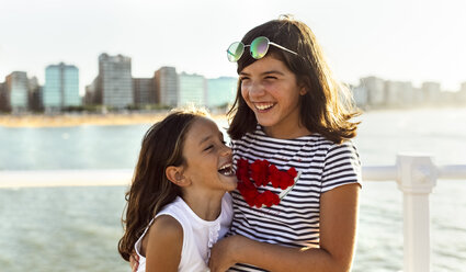 Two happy girls on the beach at sunset - MGOF002258