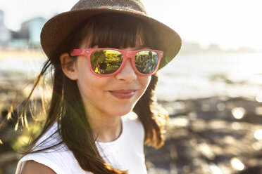 Porträt eines lächelnden Mädchens am Strand bei Sonnenuntergang - MGOF002259