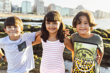 Three happy kids on the beach at sunset - MGOF002270