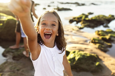 Portrait of a happy girl on the beach at sunset - MGOF002272