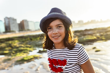 Portrait of a smiling girl on the beach at sunset - MGOF002285