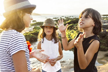 Kids playing on the beach at sunset - MGOF002297