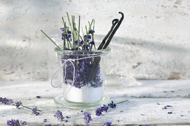 Glass of lavender sugar with avender blossoms and vanilla beans - ASF006008
