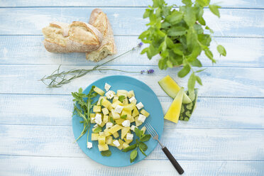 Melon salad, yellow watermelon, feta, mint and rocket on plate - MAEF011955