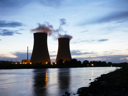 Germany, Lower Saxony, Grohnde, Grohnde Nuclear Power Plant along the Weser river during sunset - HAWF000956