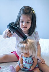 Girl blow-drying hair of doll - DAPF000312