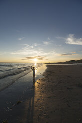 Holland, Westenschouwen, beach, girl on the beach at sunset - MYF001754