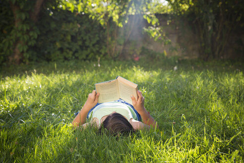 Girl reading book on a meadow - LVF005228