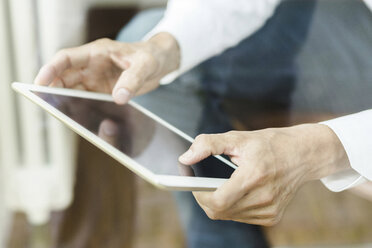 Hands of man using tablet, close-up - SBOF000184