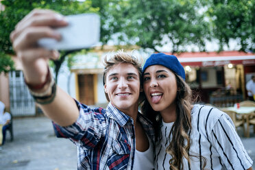 Young couple while taking selfie with smartphone - KIJF000776