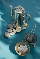 Matal tea pot on self made pebble table mat - GISF000244