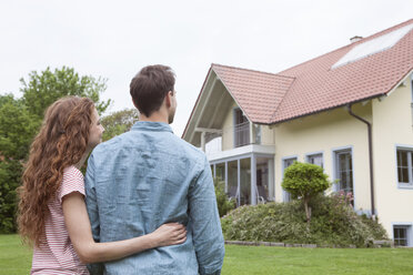 Couple in garden looking at house - RBF005077